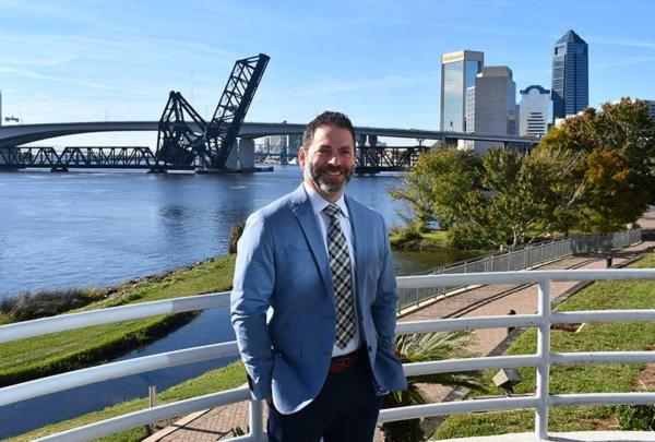 Allan Iosue in front of Jacksonville skyline.